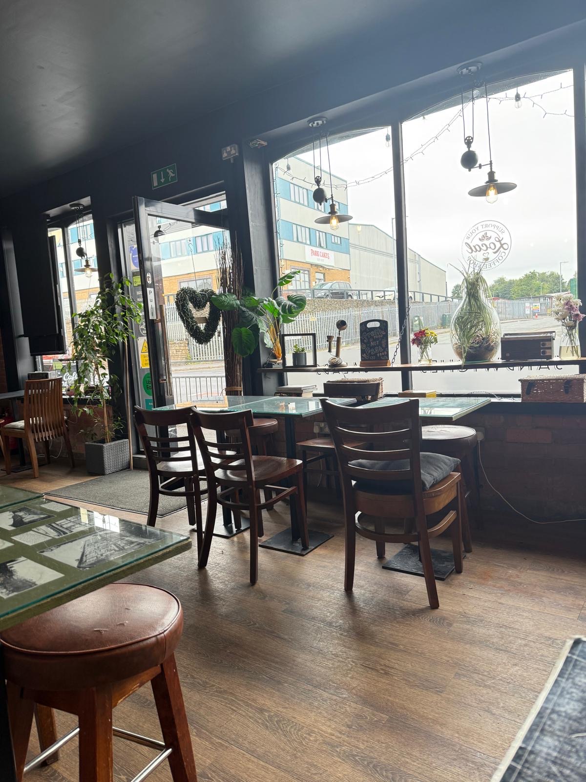 Inside Café Chico — wooden tables, warm light, chalk menu boards, a place that feels like a friend's front room